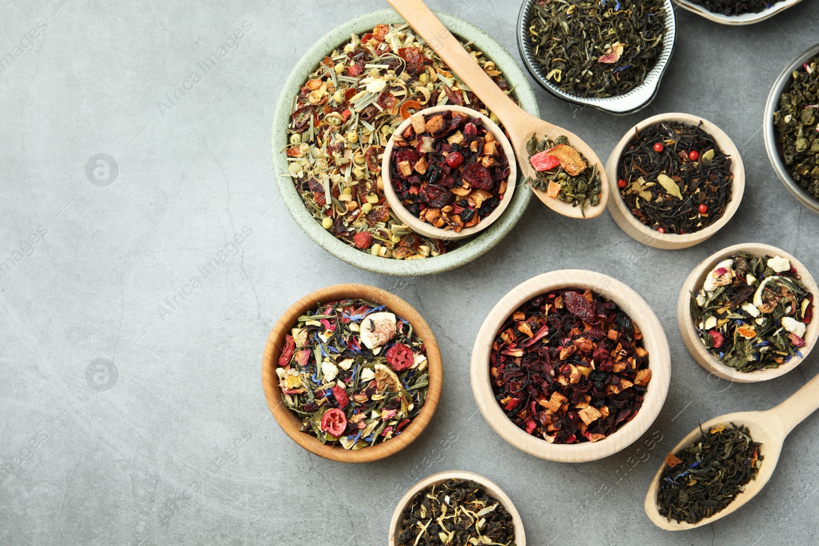 Photo of Many different herbal teas on grey table, flat lay