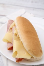 Photo of Delicious sandwich with ham and cheese on table, closeup