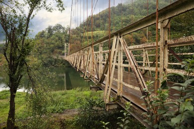 Beautiful view on rusty metal bridge over river in mountains