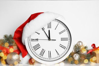 Clock and festive decor on white background. New Year countdown