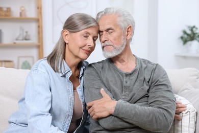 Photo of Portrait of affectionate senior couple at home