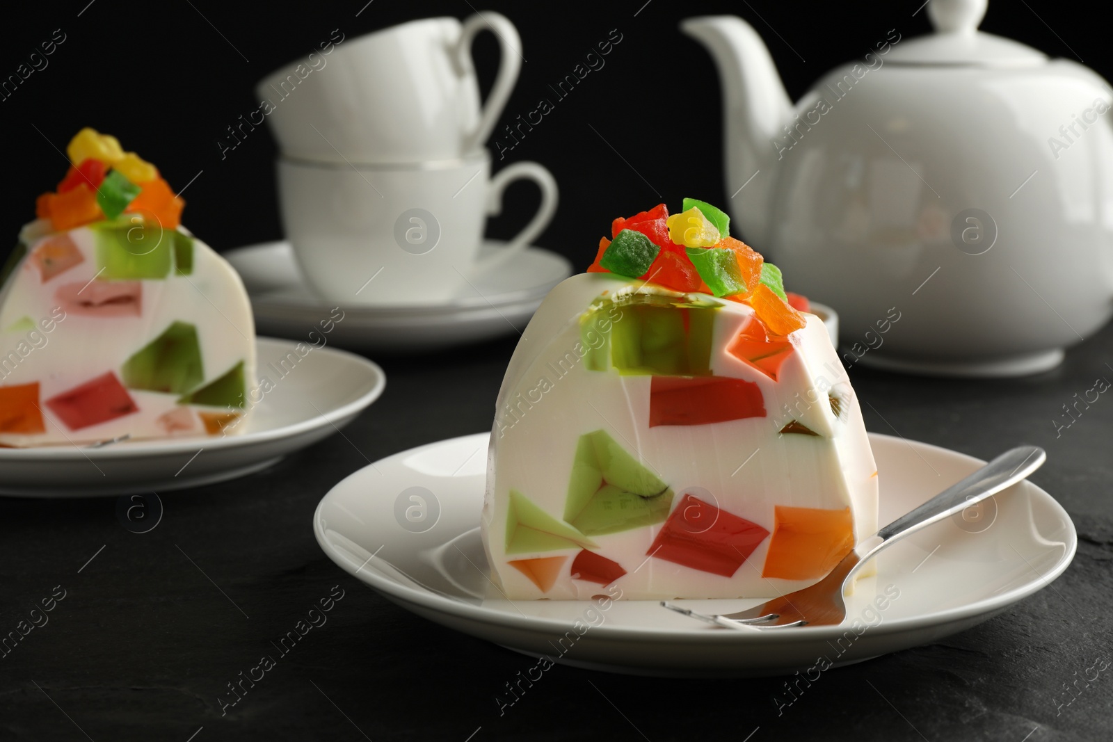 Photo of Delicious broken glass jelly dessert on black table