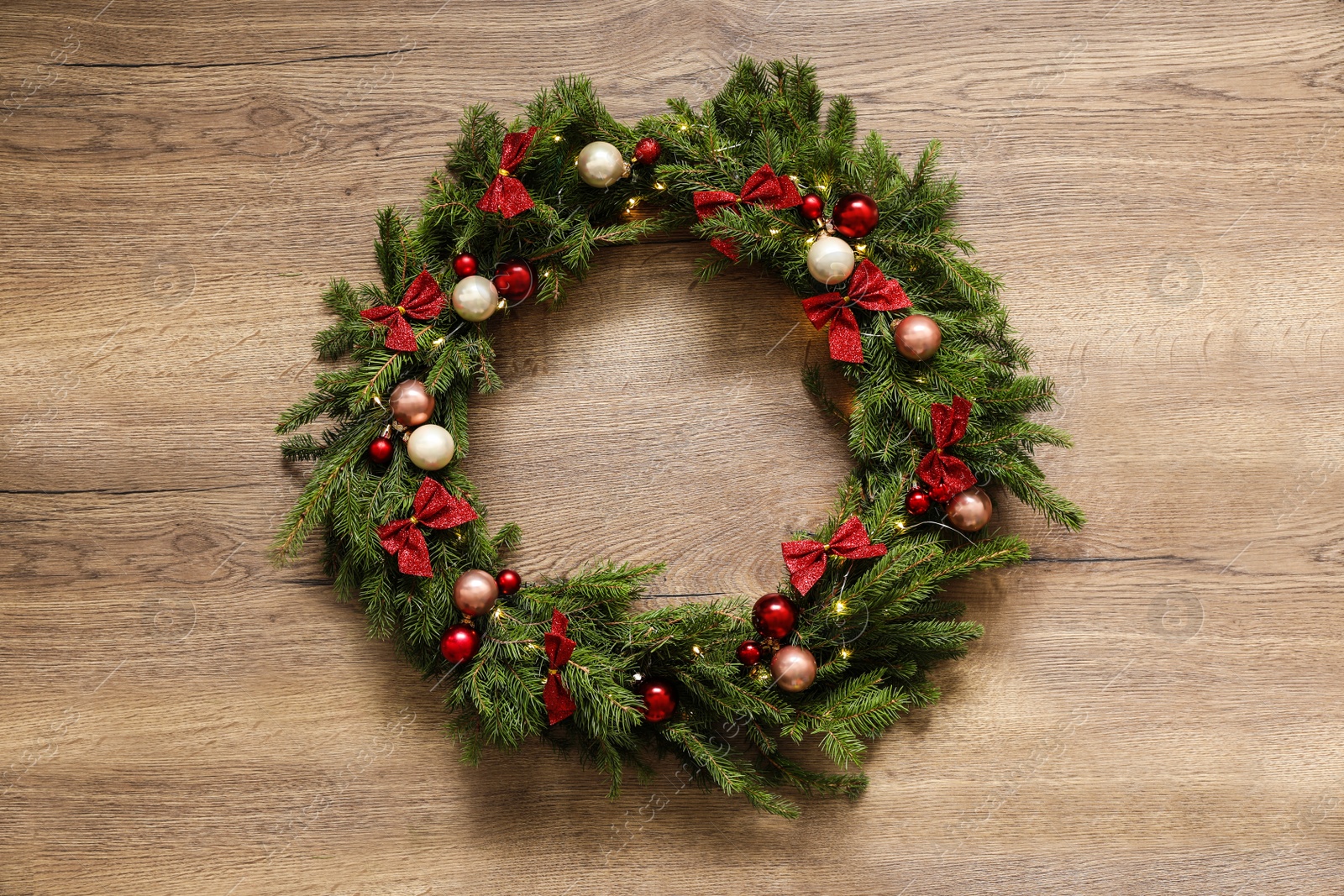 Photo of Beautiful Christmas wreath with festive decor on wooden background, top view