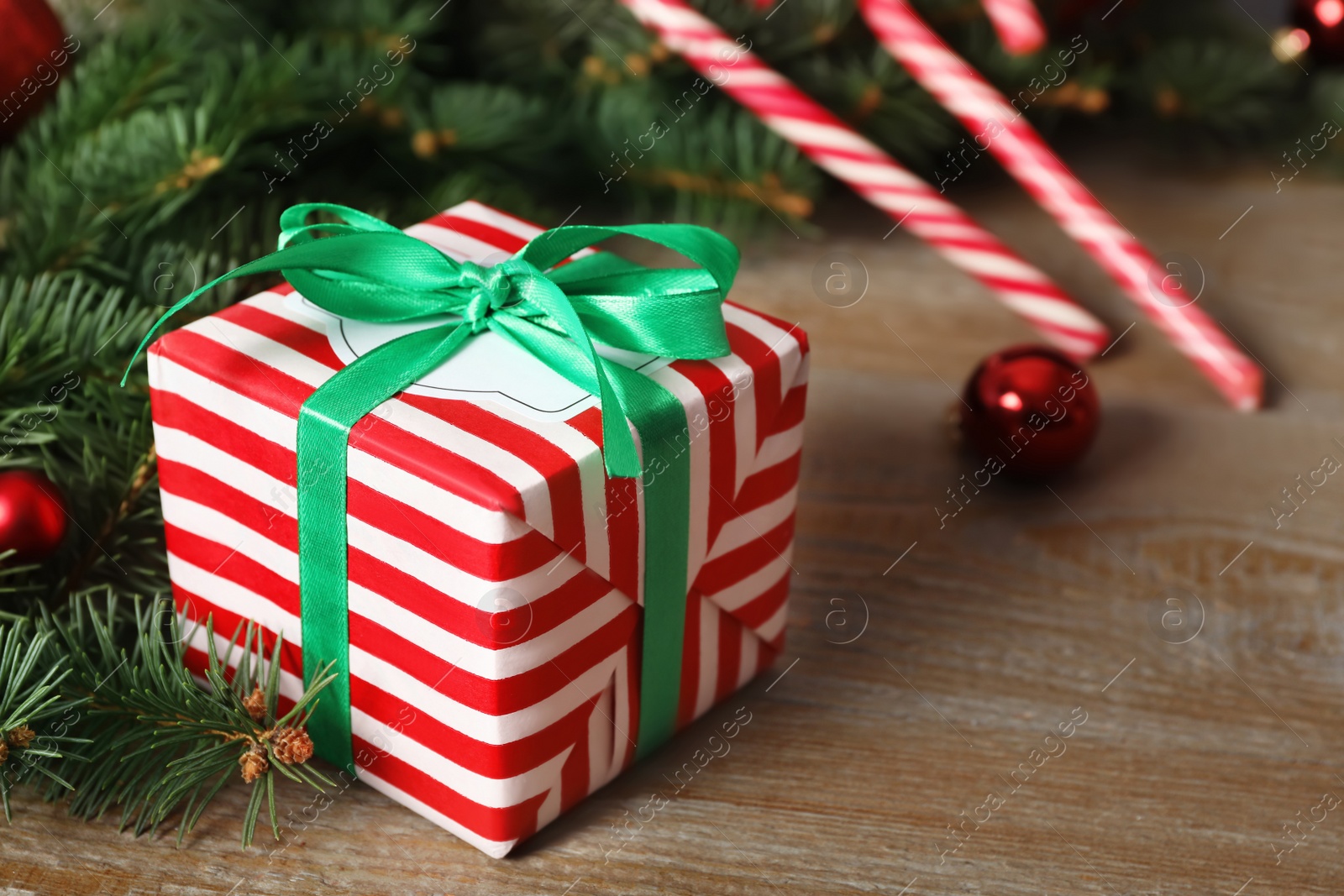 Photo of Christmas gift box on wooden table, closeup