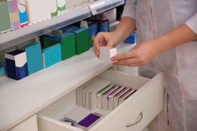 Image of Professional pharmacist with medicine in drugstore, closeup