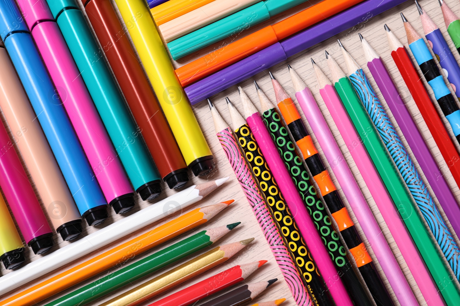 Photo of Different school stationery on wooden table, flat lay