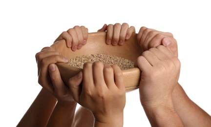 Photo of Poor people holding wooden bowl with grains on white background, closeup