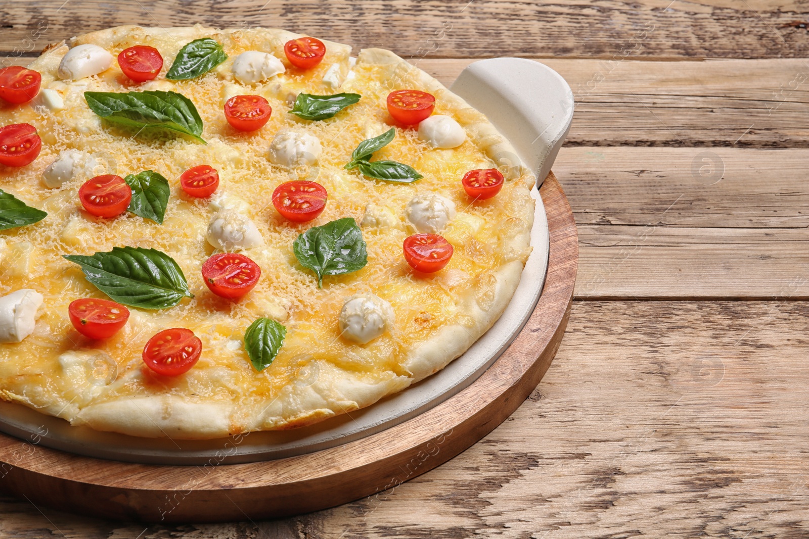 Photo of Fresh tasty homemade pizza on wooden table, closeup