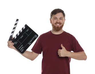 Making movie. Smiling man with clapperboard showing thumb up on white background