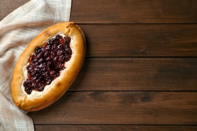 Photo of Delicious sweet cottage cheese pastry with cherry jam on wooden table, top view. Space for text