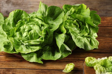 Photo of Fresh green butter lettuce on wooden table