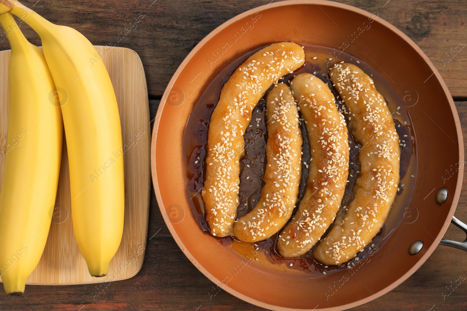 Photo of Delicious fresh and fried bananas on wooden table, flat lay