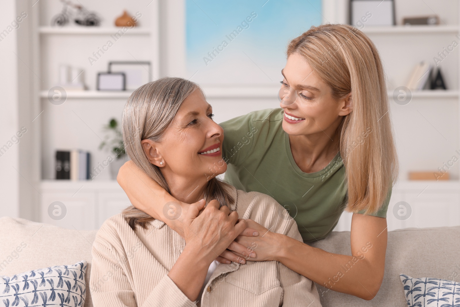 Photo of Happy mature mother and her daughter at home