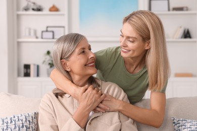 Photo of Happy mature mother and her daughter at home