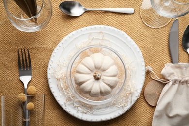 Photo of Autumn place setting with pumpkin on table, flat lay