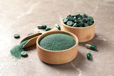 Photo of Spirulina pills and powder on color table