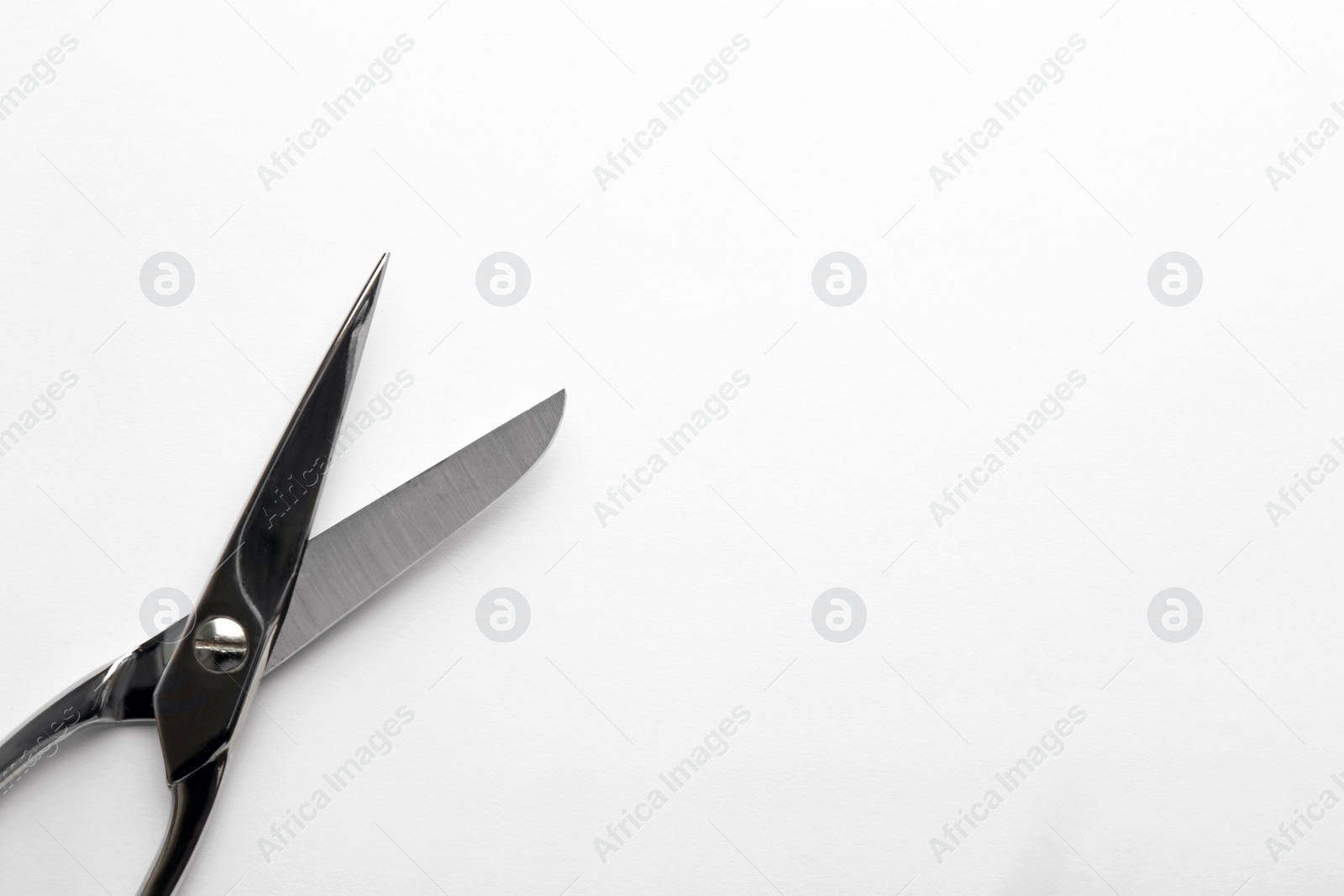 Photo of Pair of sharp scissors on white background