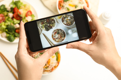 Photo of Blogger taking picture of lunch at table, top view