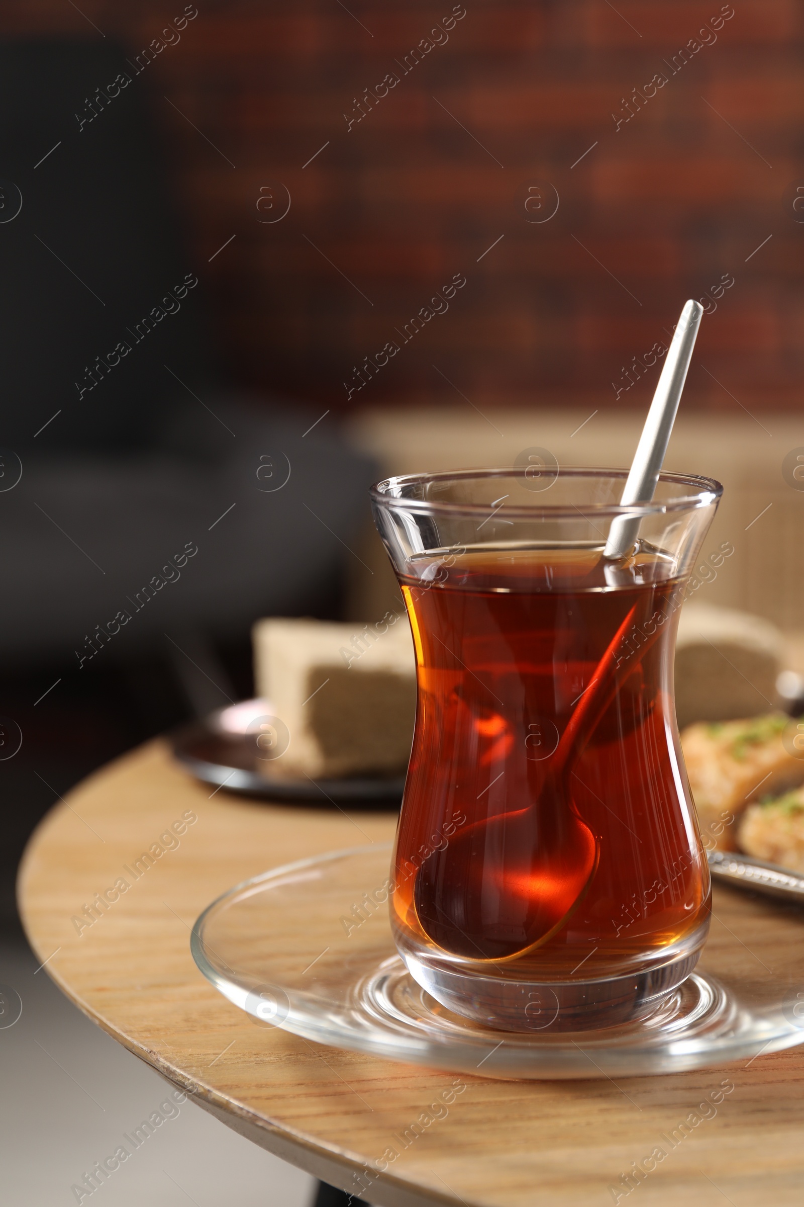 Photo of Traditional Turkish tea in glass on wooden table