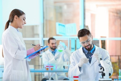 Photo of Young scientists working in laboratory. Chemical analysis