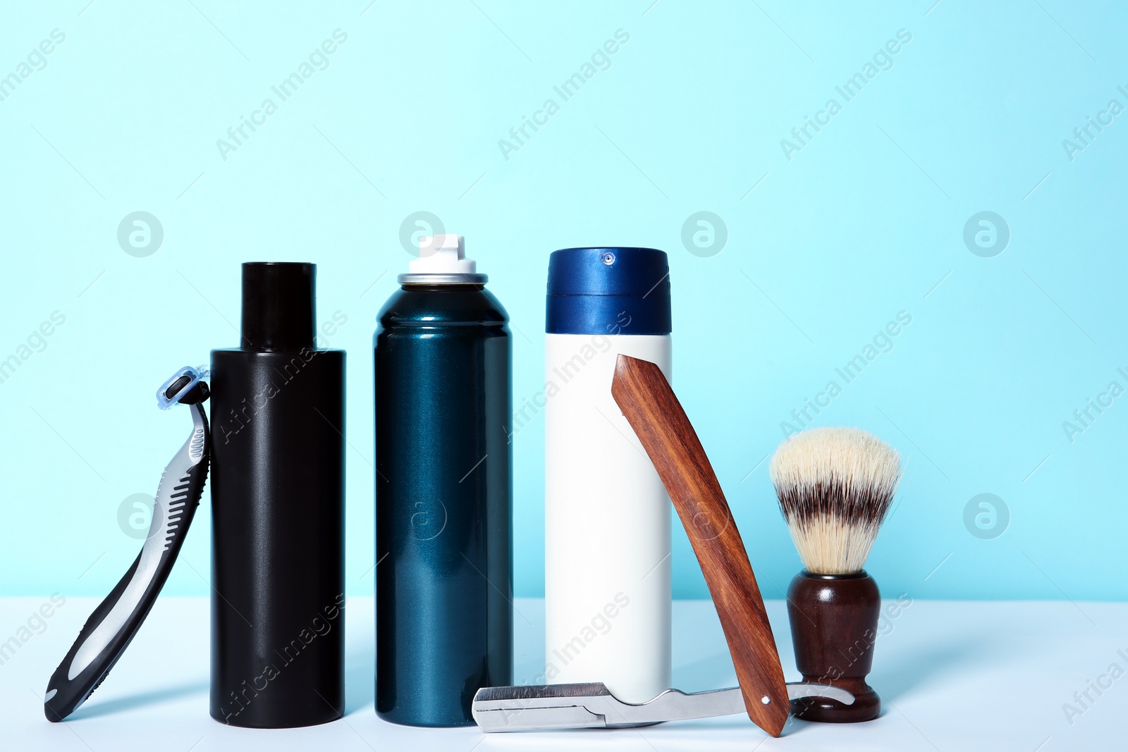 Photo of Shaving accessories for men on table against color background