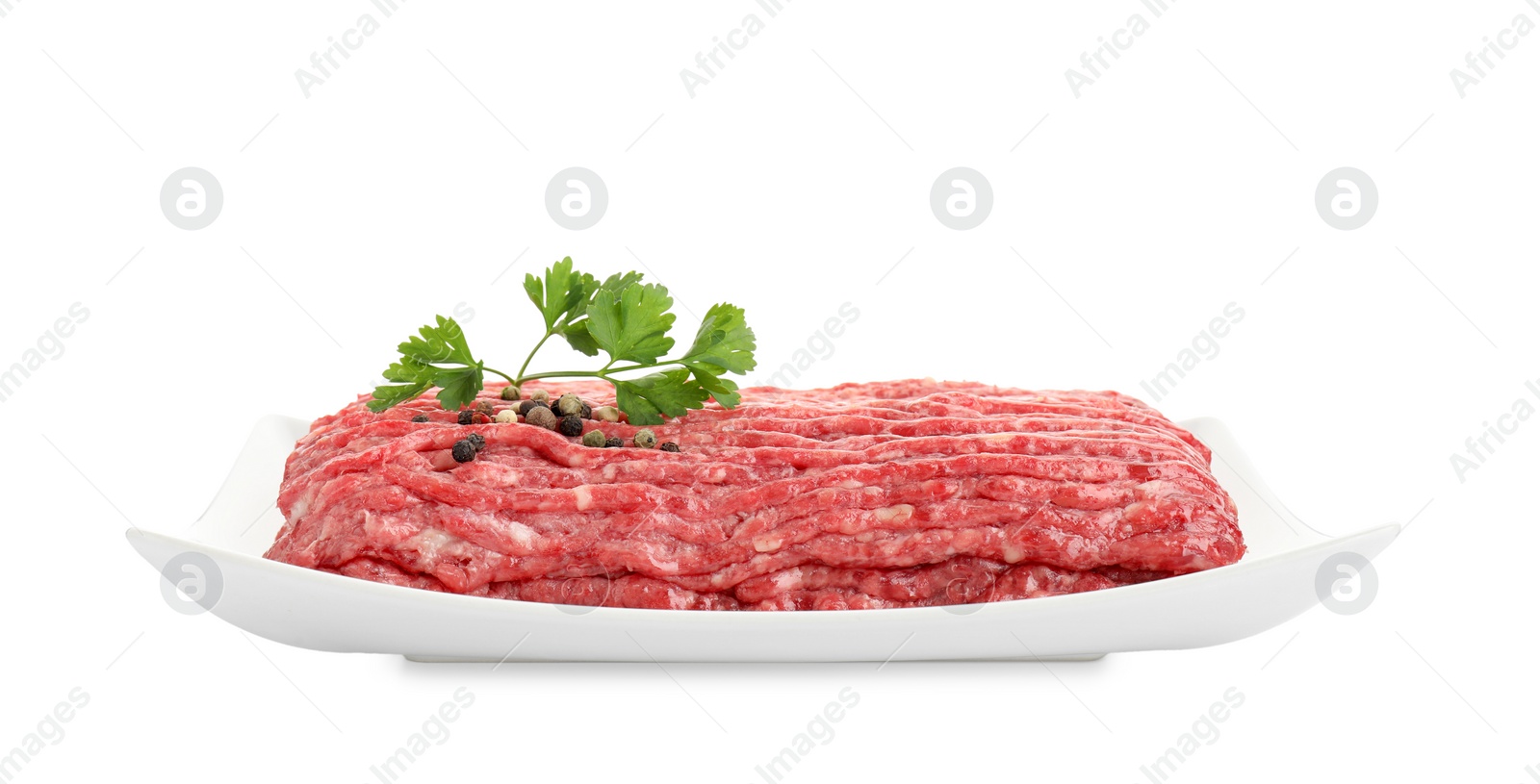 Photo of Raw ground meat, parsley and peppercorns isolated on white