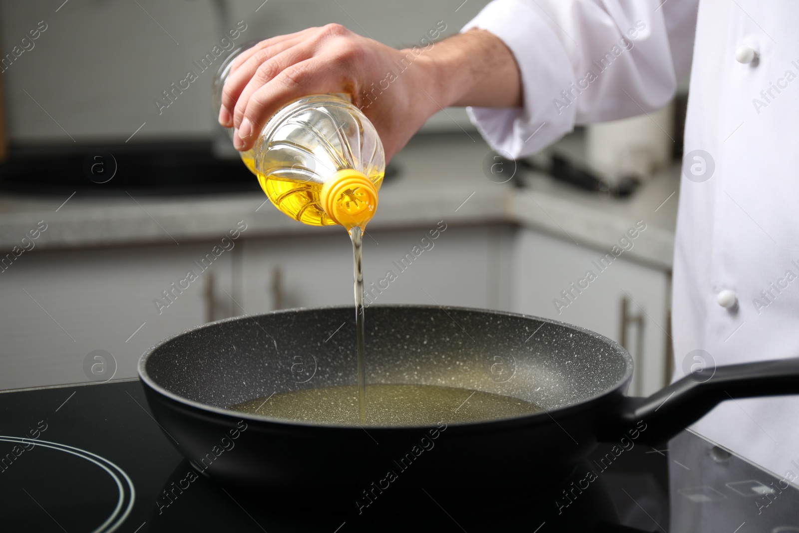 Photo of Man pouring cooking oil from bottle into frying pan, closeup