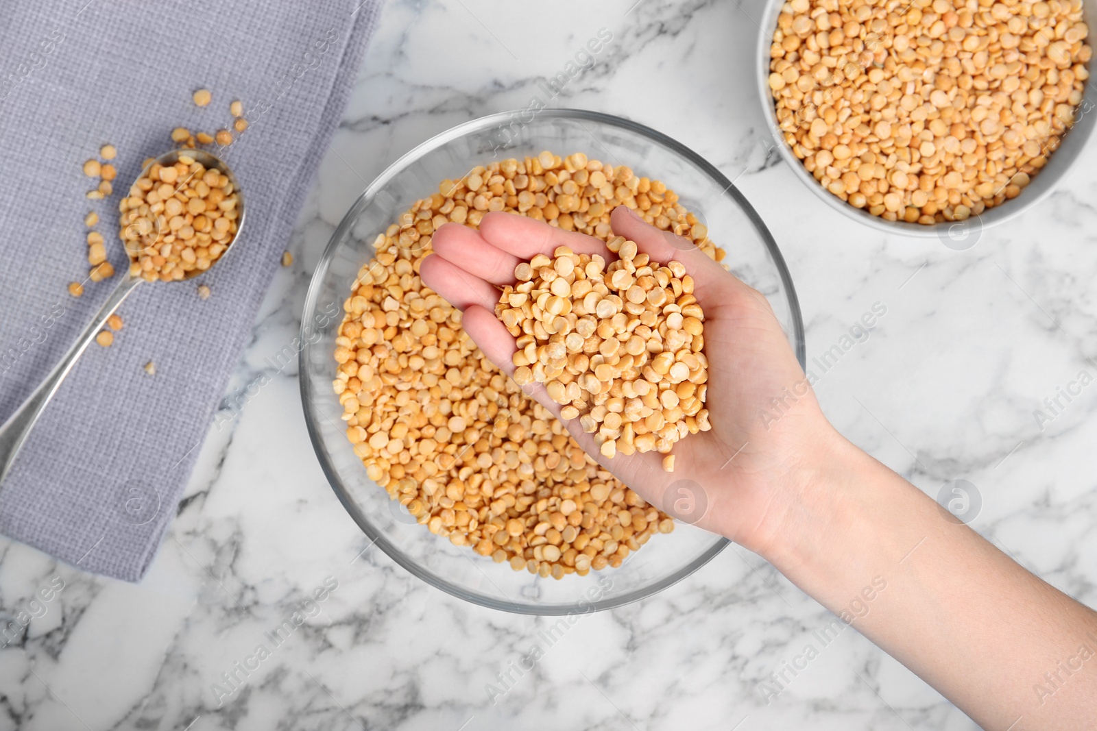 Photo of Woman holding dried peas over table, top view