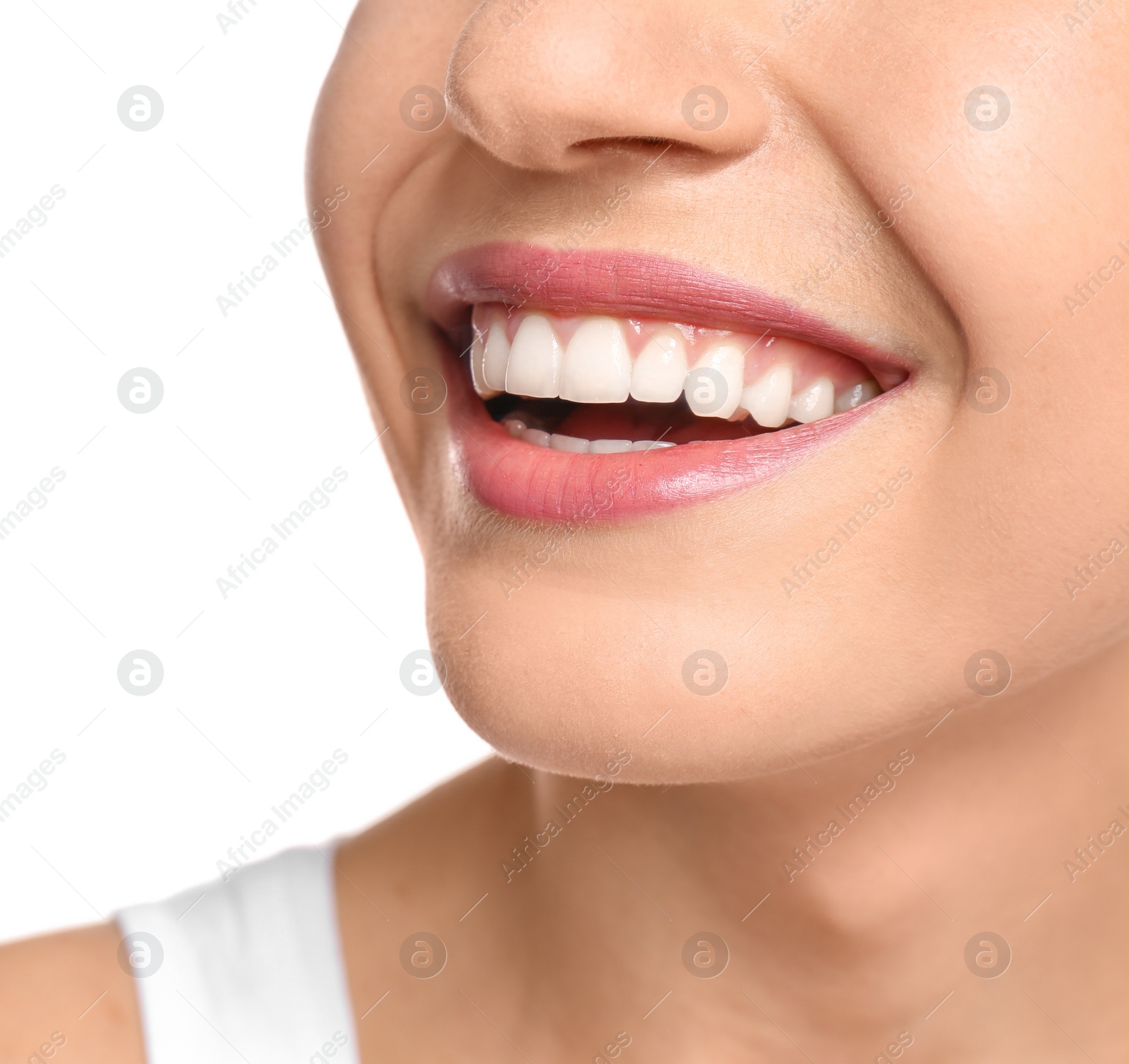 Photo of Young woman with beautiful smile on white background, closeup. Teeth whitening