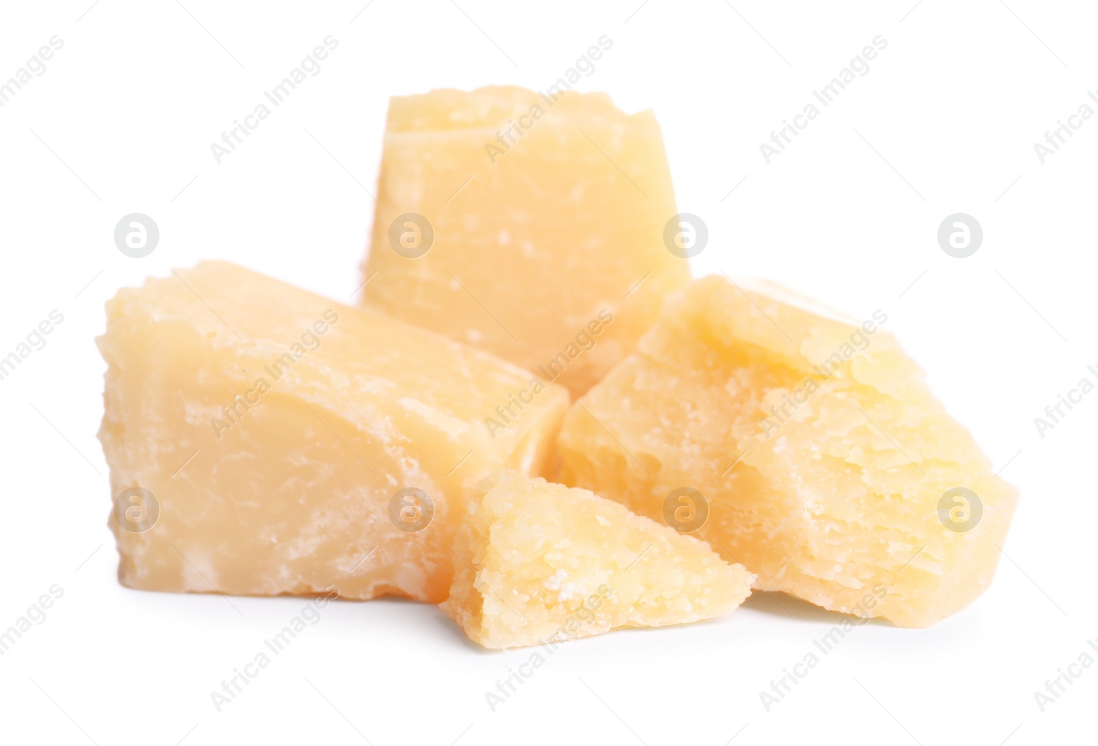 Photo of Pieces of delicious parmesan cheese on white background