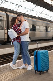 Long-distance relationship. Beautiful couple on platform of railway station