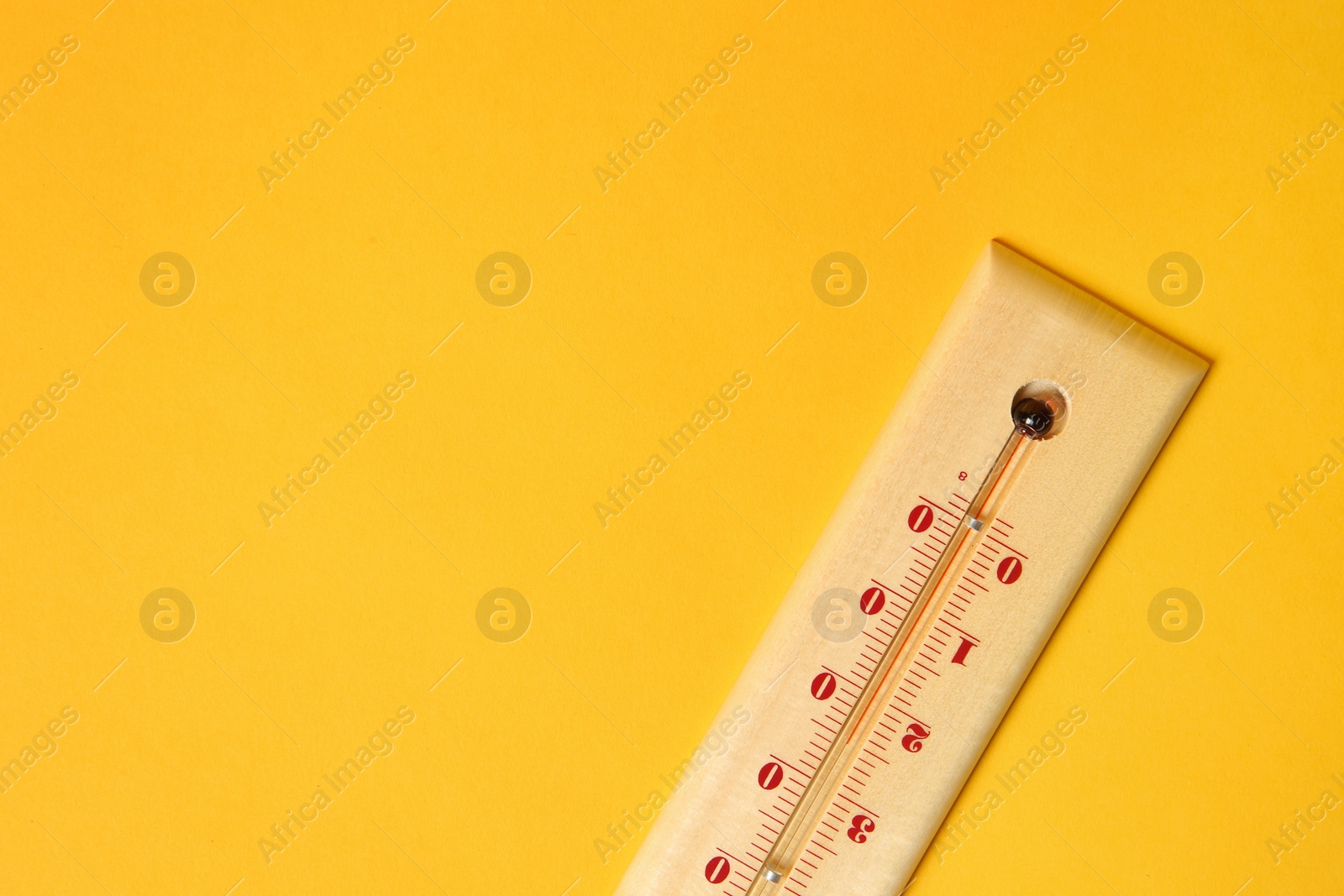 Photo of Weather thermometer on yellow background, top view. Space for text