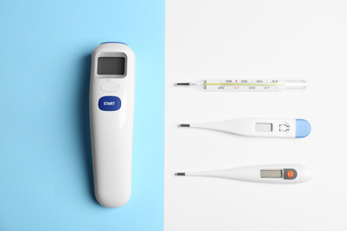 Photo of Different thermometers on color background, flat lay