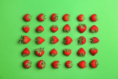 Flat lay composition with with tasty ripe strawberries on color background