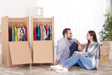 Photo of Young couple near wardrobe boxes at home