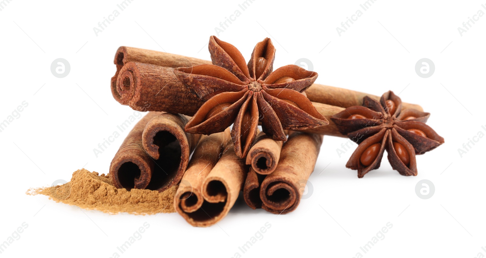 Photo of Dry aromatic cinnamon sticks, powder and anise stars isolated on white