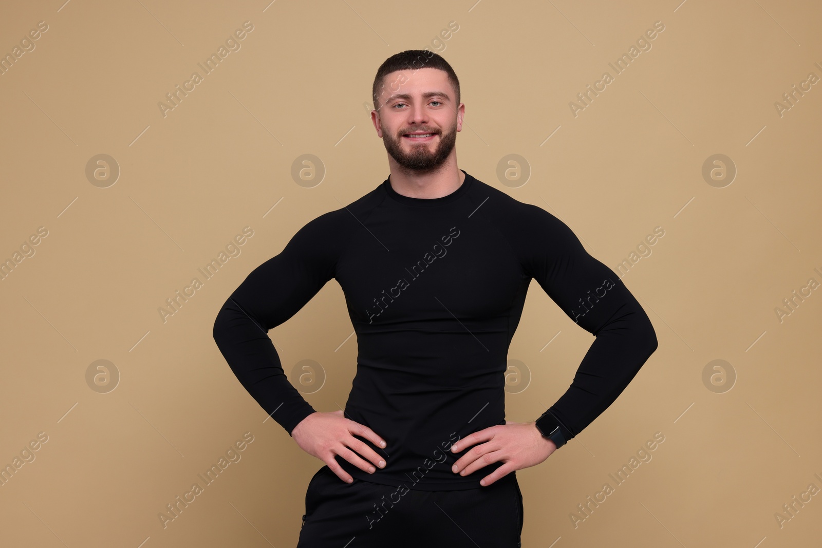 Photo of Portrait of handsome sportsman on brown background