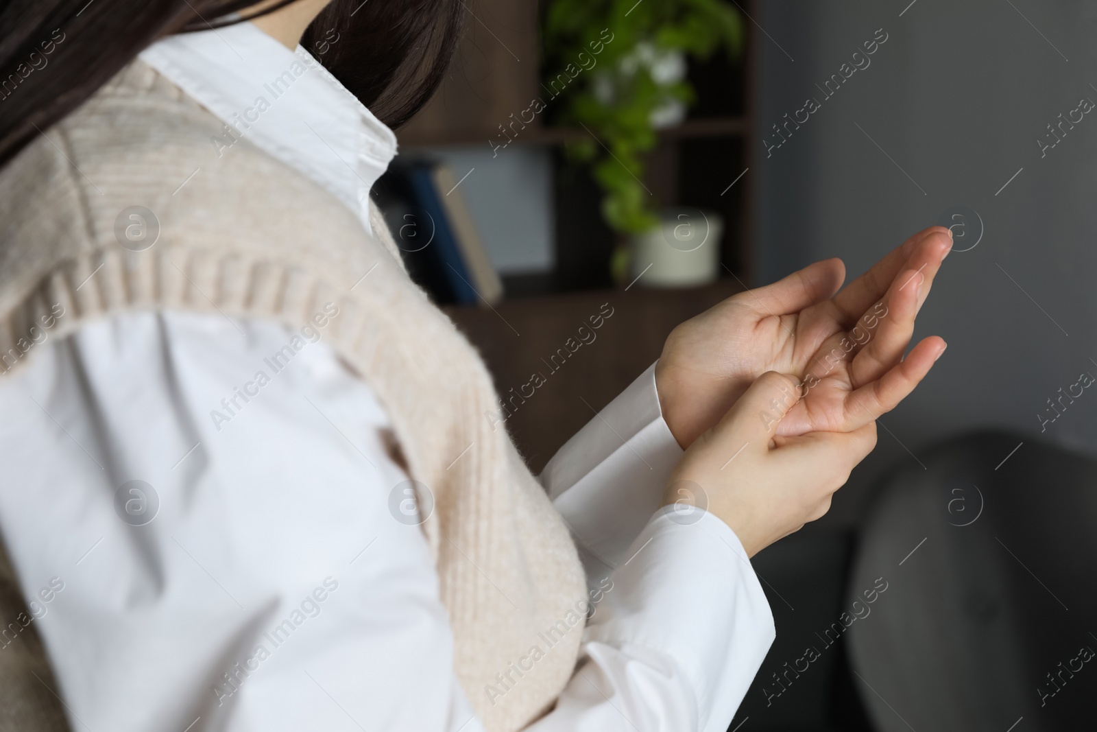 Photo of Woman suffering from trigger finger at home, closeup