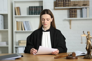 Photo of Judge working with document at table indoors