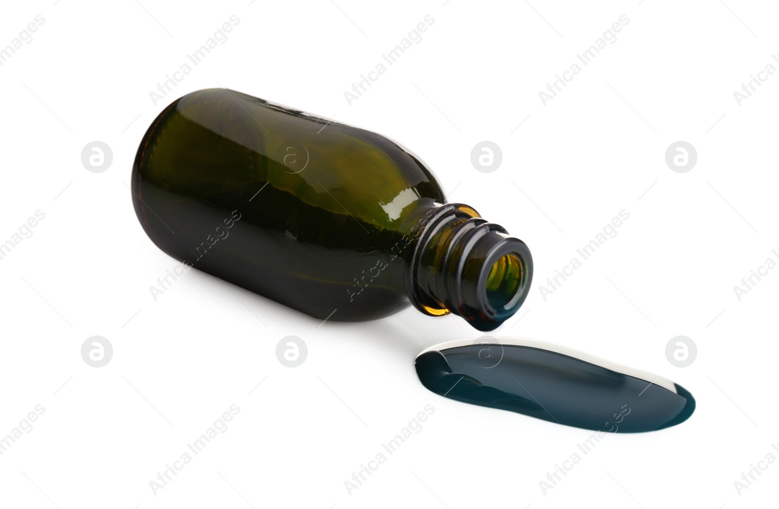 Photo of Overturned bottle and spilled brilliant green on white background
