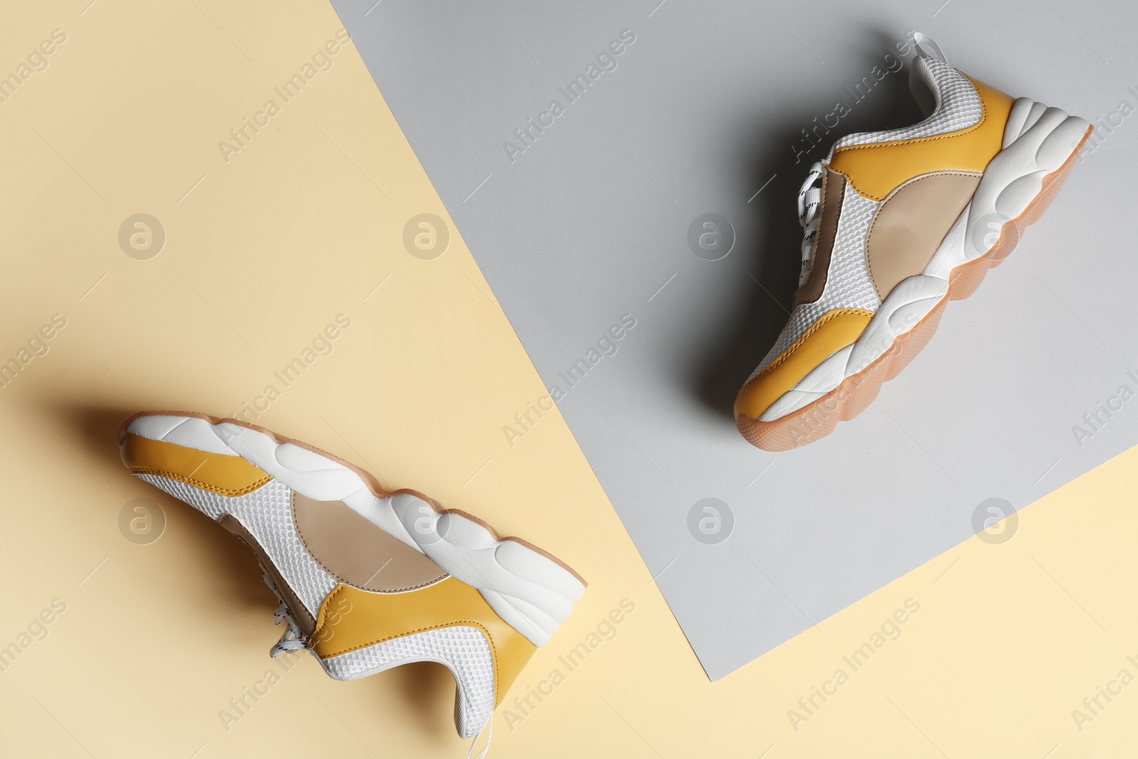 Photo of Pair of sports shoes on color background, top view. Space for text