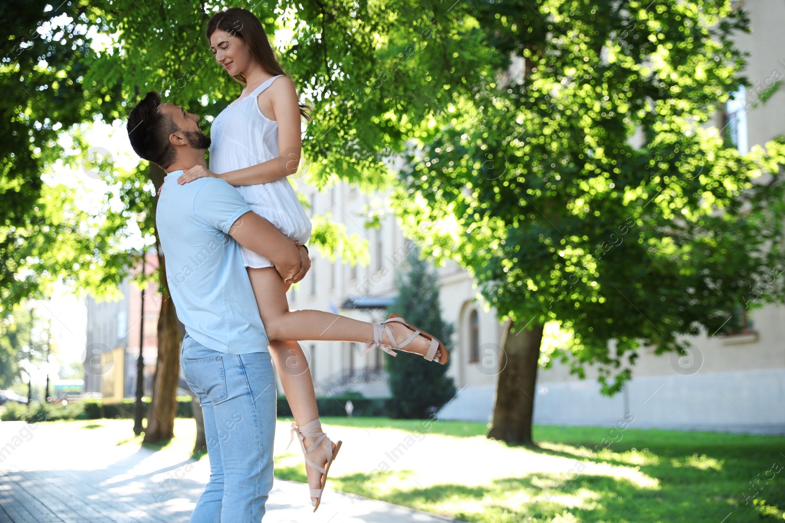 Photo of Lovely young couple dancing together in park on sunny day