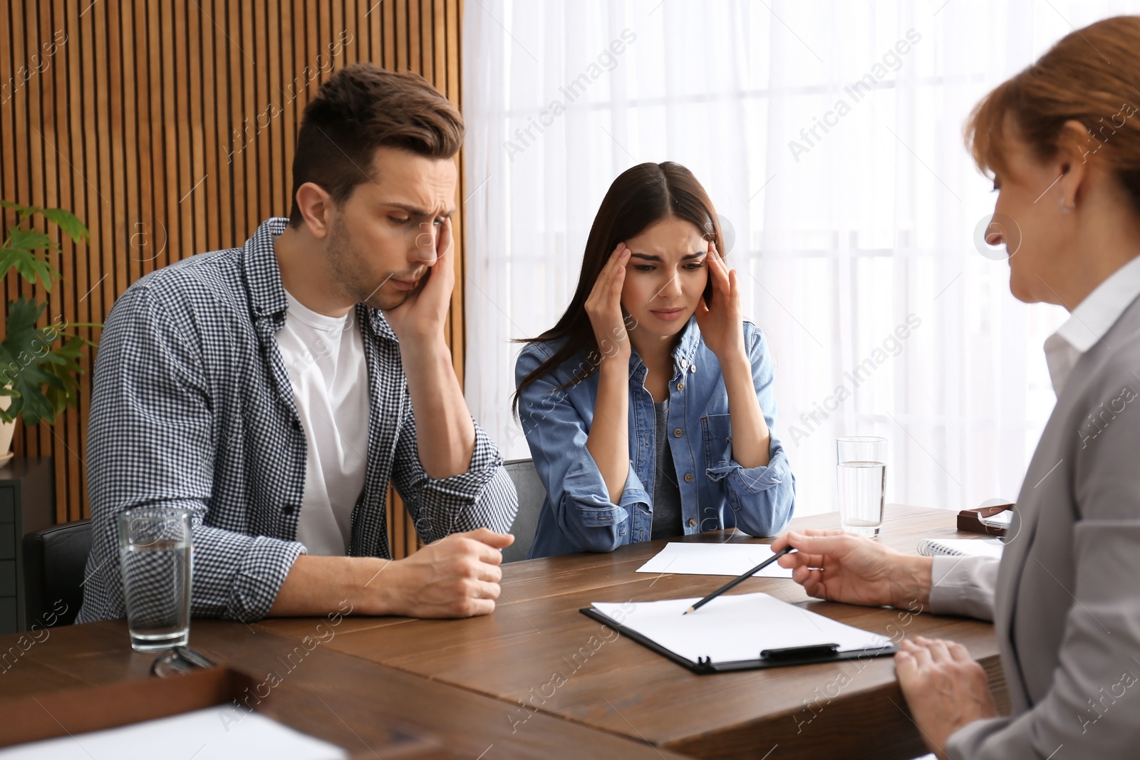 Photo of Lawyer having meeting with young couple in office