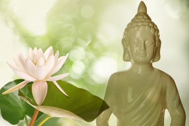 Image of Beautiful ceramic Buddha sculpture and lotus flower on color background