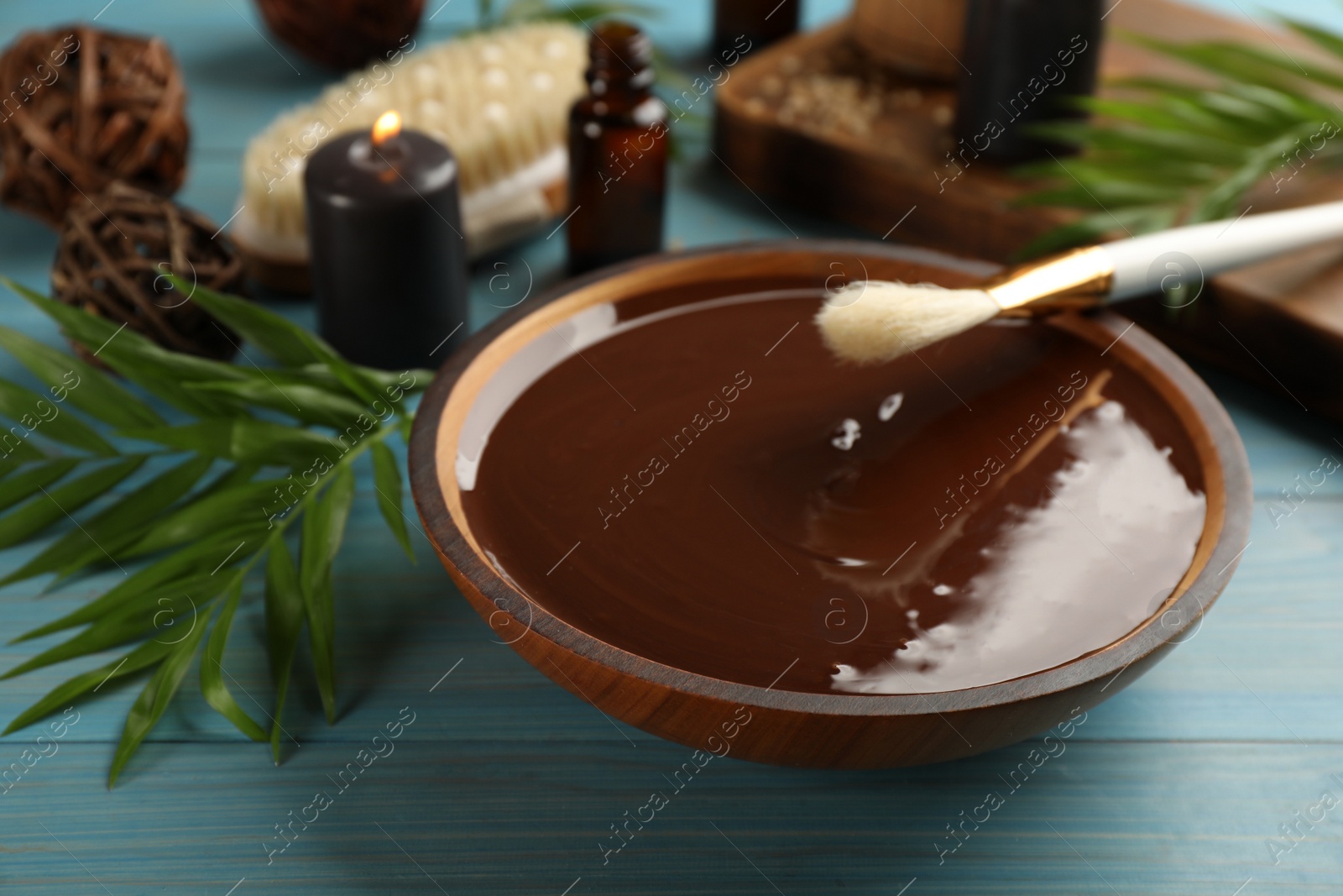 Photo of Composition with cosmetic product for spa body wraps on light blue wooden background