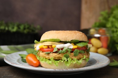 Photo of Tasty vegan burger with vegetables, patty and microgreens on wooden table, closeup