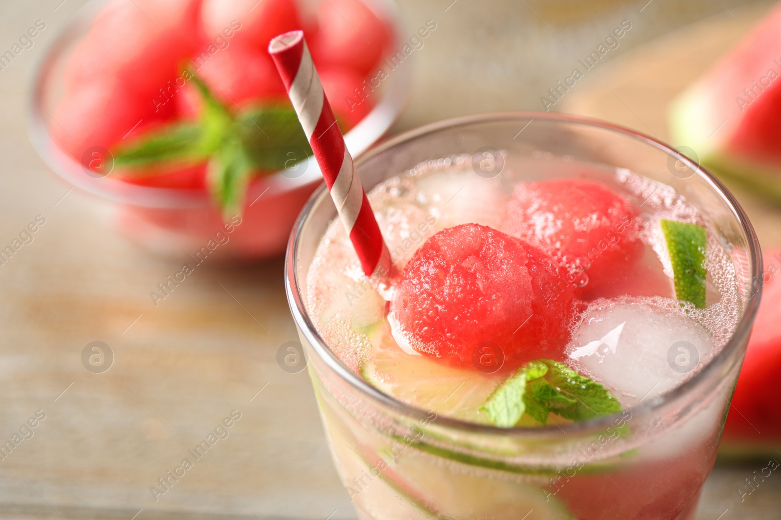 Photo of Glass of refreshing watermelon drink on wooden table, closeup