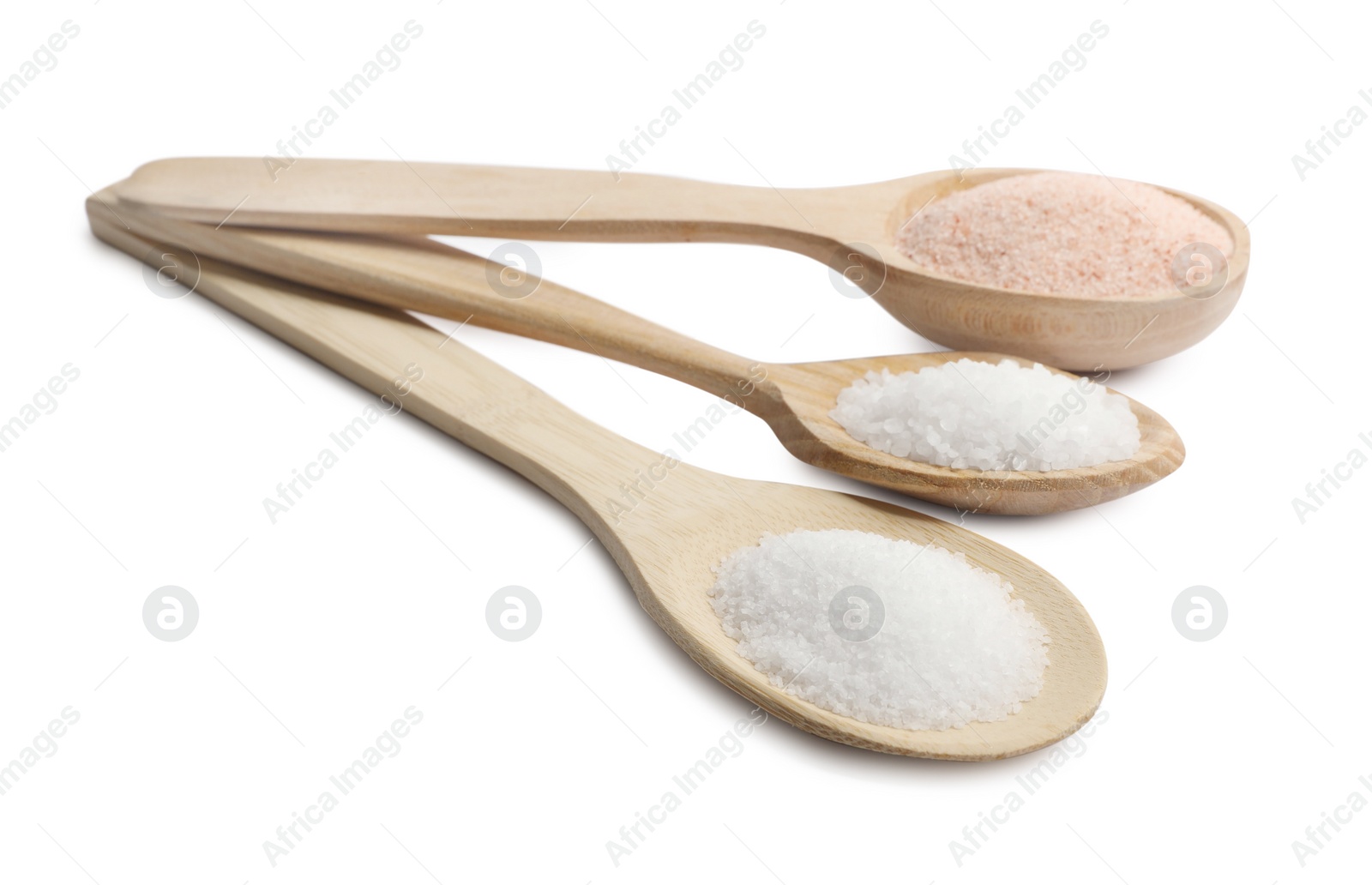 Photo of Different types of natural salt in wooden spoons isolated on white