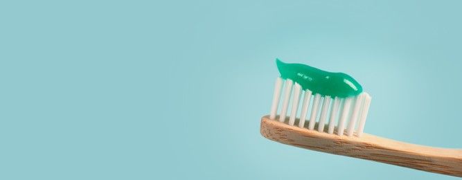 Image of Brush with toothpaste on light blue background, space for text. Banner design