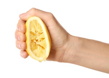 Woman squeezing lemon half on white background, closeup